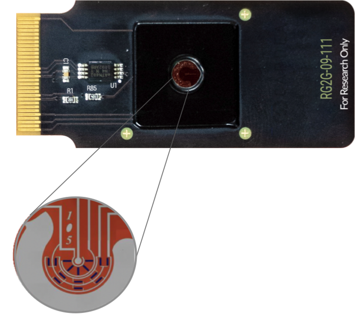 The current CRISPR-Chip. The transistors are the dark rectangular shapes seen in the circle. Image...